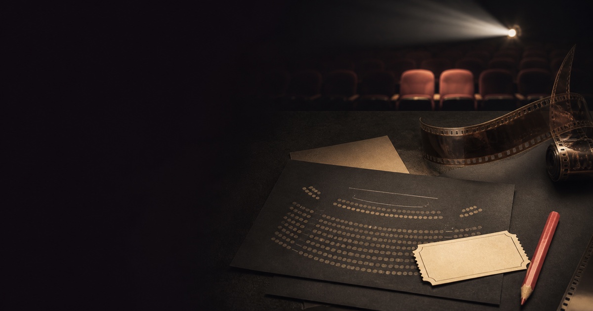 A cinema seating chart, film strip, and ticket under a projector beam